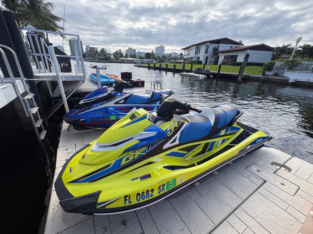 Two Yamaha GP1800R WaveRunners on a floating dock, ready to ride