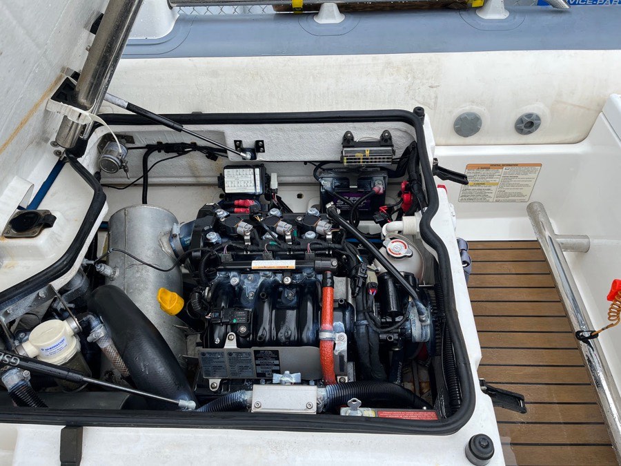 Technician working in a jet ski engine bay